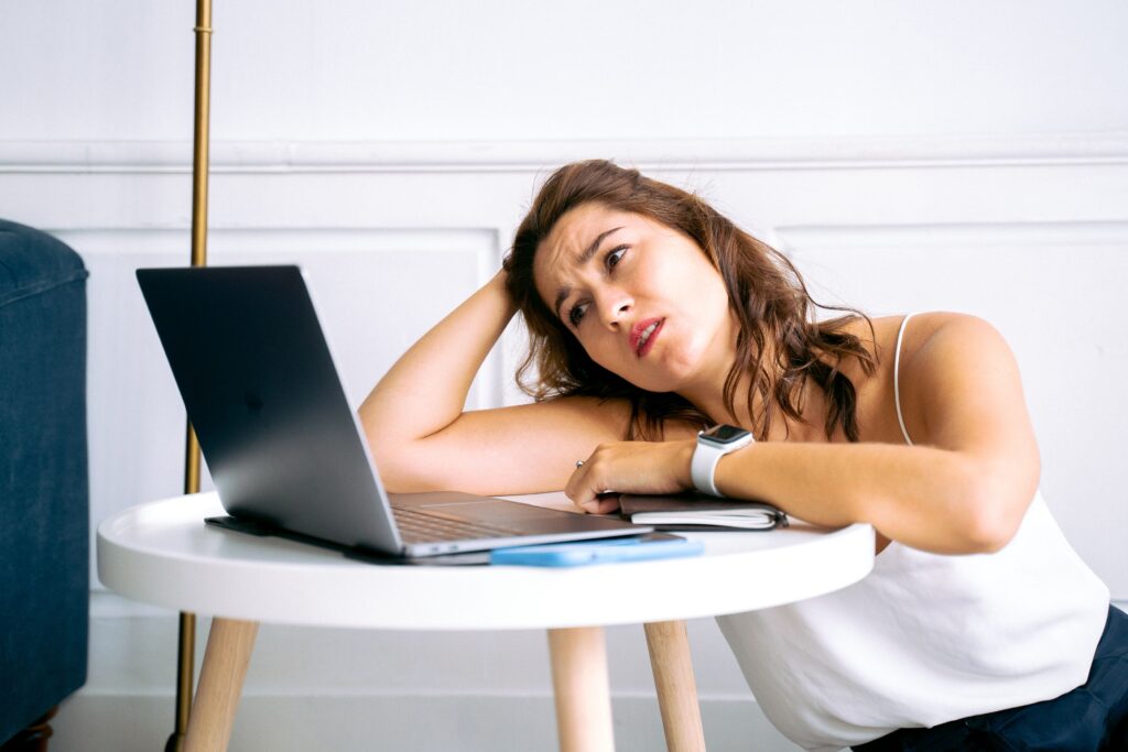 Mujer con expresión de confusión revisa su celular, notando que se quedó sin señal de repente, una posible señal de SIM swapping